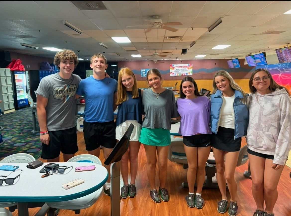 Seven Yabbey students smiling together at the bowling alley