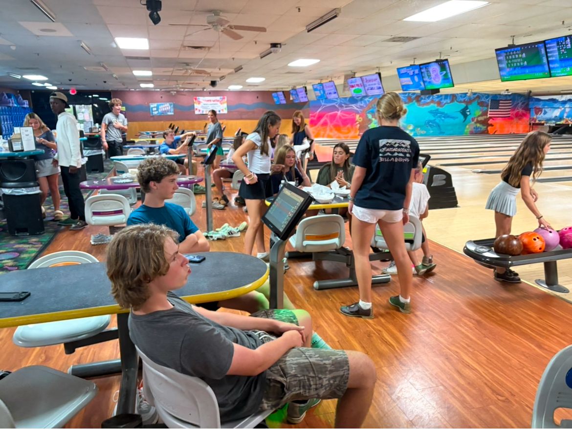 Students bowling and hanging out at the lanes during a Yabbey outing